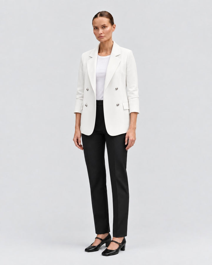 Luna Moda white double-breasted blazer worn by a model with black trousers and heels against a neutral background