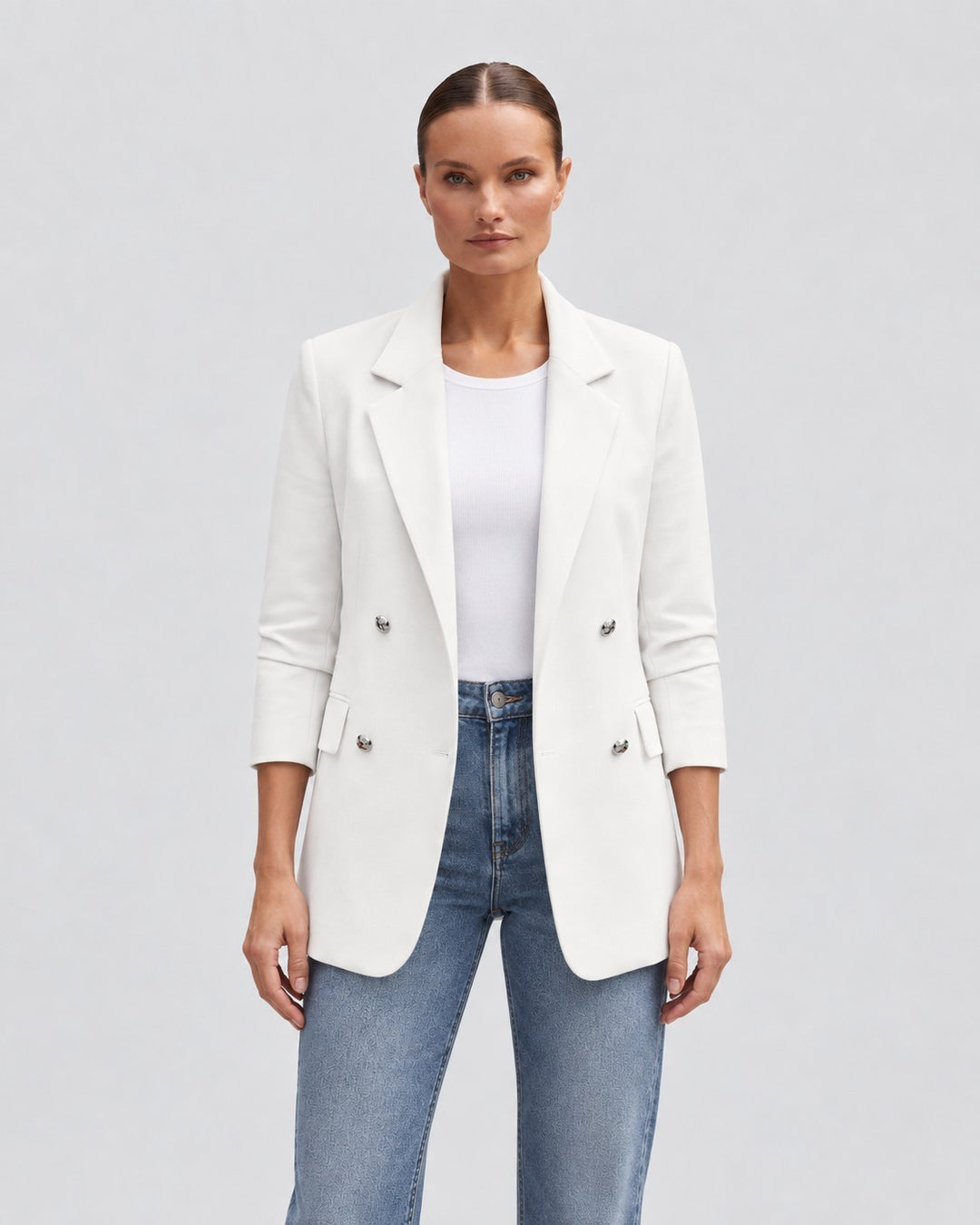 Luna Moda white double-breasted blazer worn by a model with blue jeans for a chic casual look