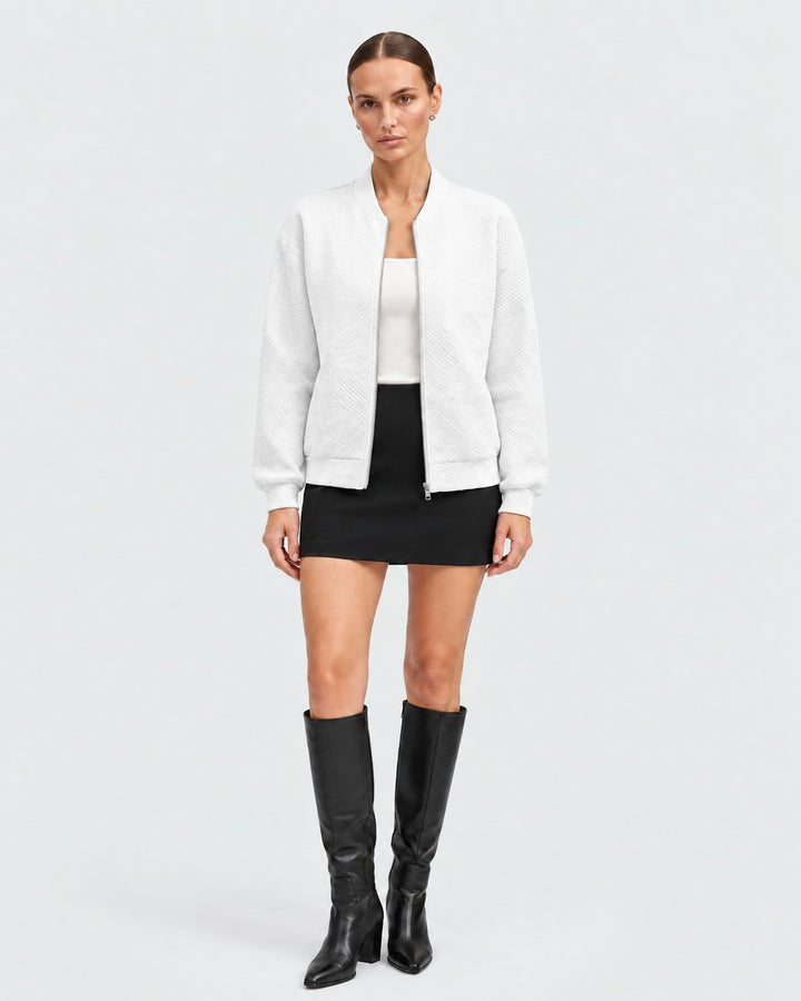 Luna Moda white bomber jacket with a subtle geometric pattern, featuring a front zip and ribbed cuffs on a model.