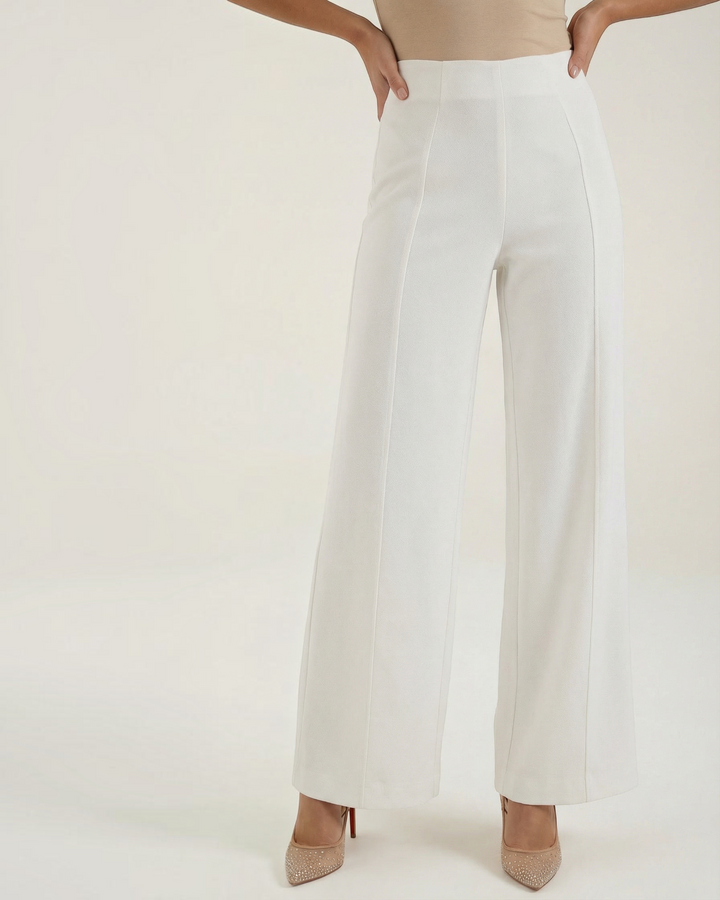 Luna Moda high-waisted white tailored trousers with wide legs and front pleats, worn with a beige top and heels.