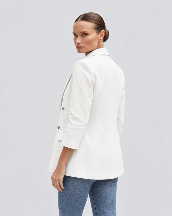Luna Moda white oversized long coat worn by a woman, featuring a tailored fit and button details, back view.
