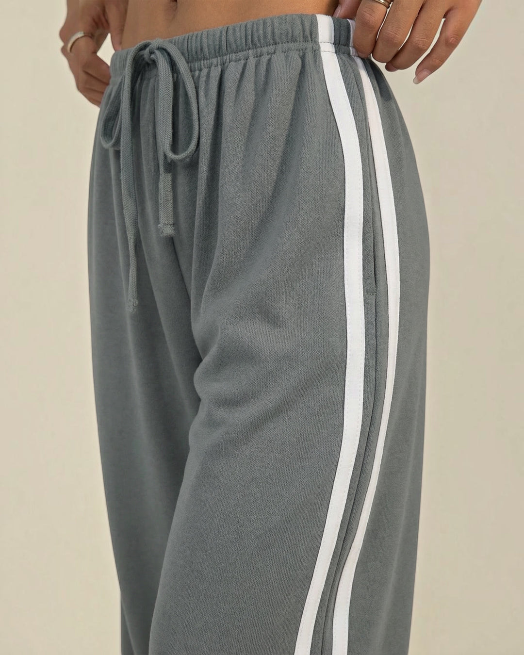 Luna Moda grey wide-leg sweatpants with white side stripes and an adjustable drawstring waist for a relaxed fit.