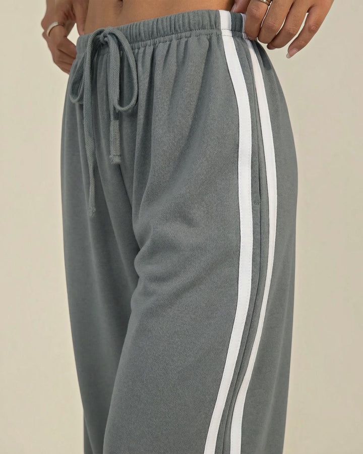 Luna Moda grey wide-leg sweatpants with white side stripes and an adjustable drawstring waist for a relaxed fit.