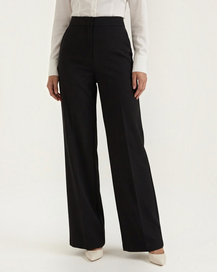 Luna Moda Stefania high-waisted wide-leg black tailored trousers with front pleats and clean architectural lines.