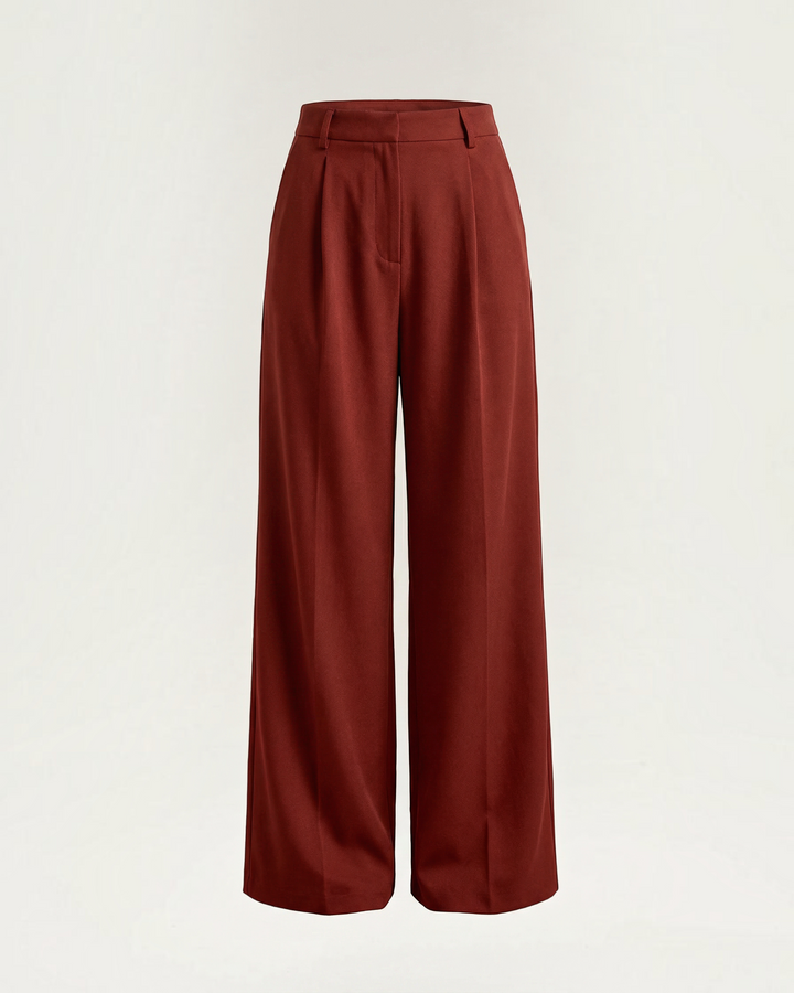 Luna Moda Stefania high-waisted wide-leg trousers in deep rust red with front pleats and architectural tailoring.