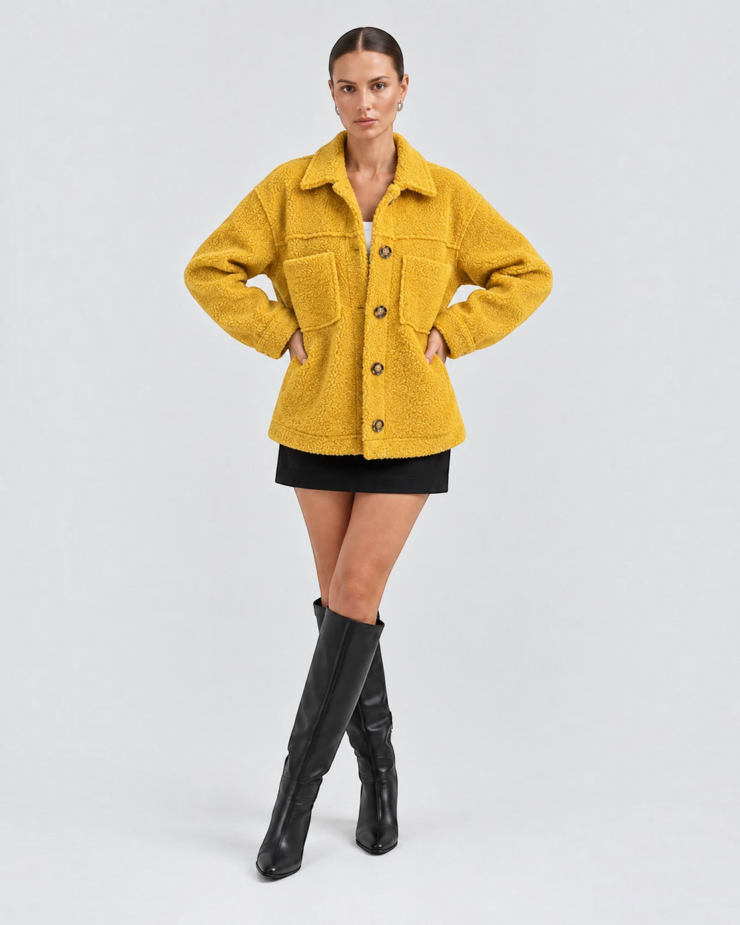 Model wearing a Luna Moda yellow textured fleece button-up jacket with a collar and front pockets