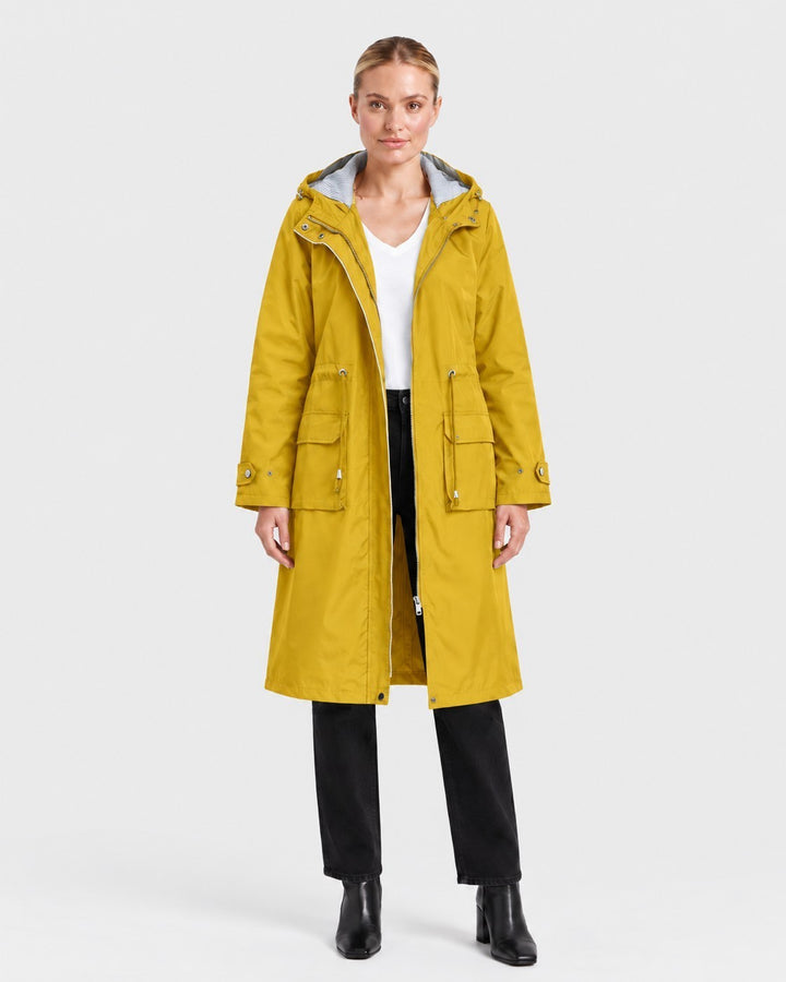Luna Moda yellow lightweight hooded trench coat with adjustable waist and cuffs worn by a woman on white background