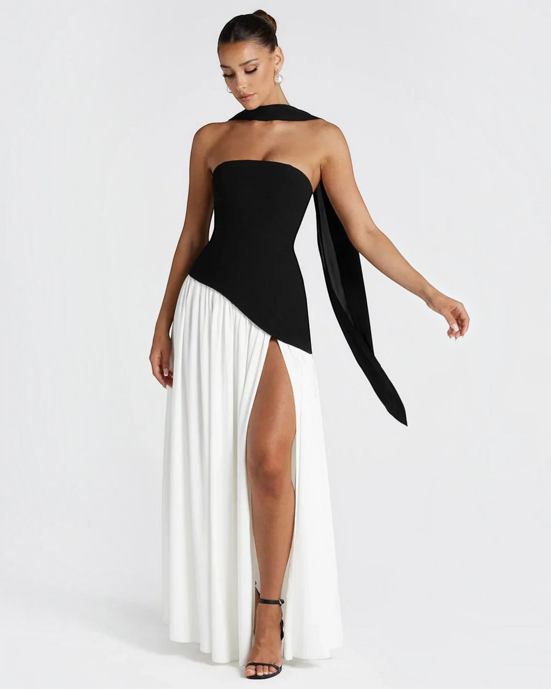 Luna Moda Zadie maxi dress featuring a black strapless bodice with a scarf detail and a white skirt with a high slit.