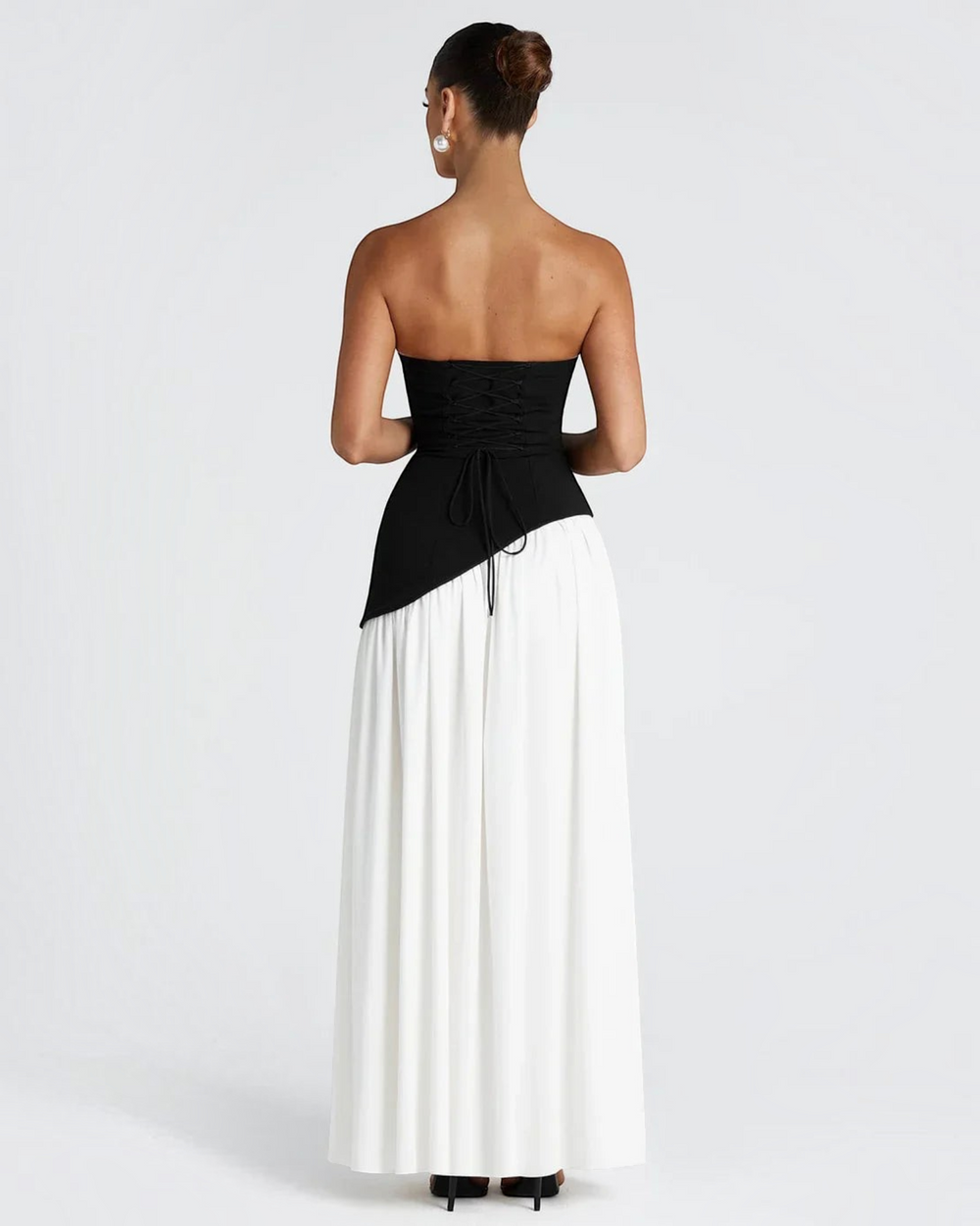 Luna Moda Zadie maxi dress featuring a black corset-style bodice with lace-up back and a flowing white pleated skirt.
