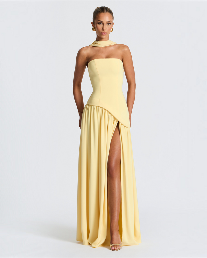 Luna Moda Zadie yellow maxi dress with a halter neckline, fitted bodice, and a high side slit on a model.