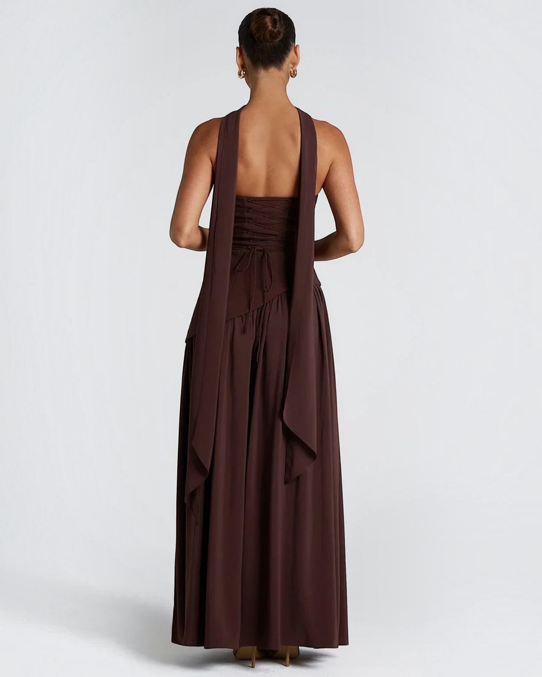Luna Moda Zadie maxi dress in dark brown with a deep halter neckline, open back, and corset-style lace-up detail.