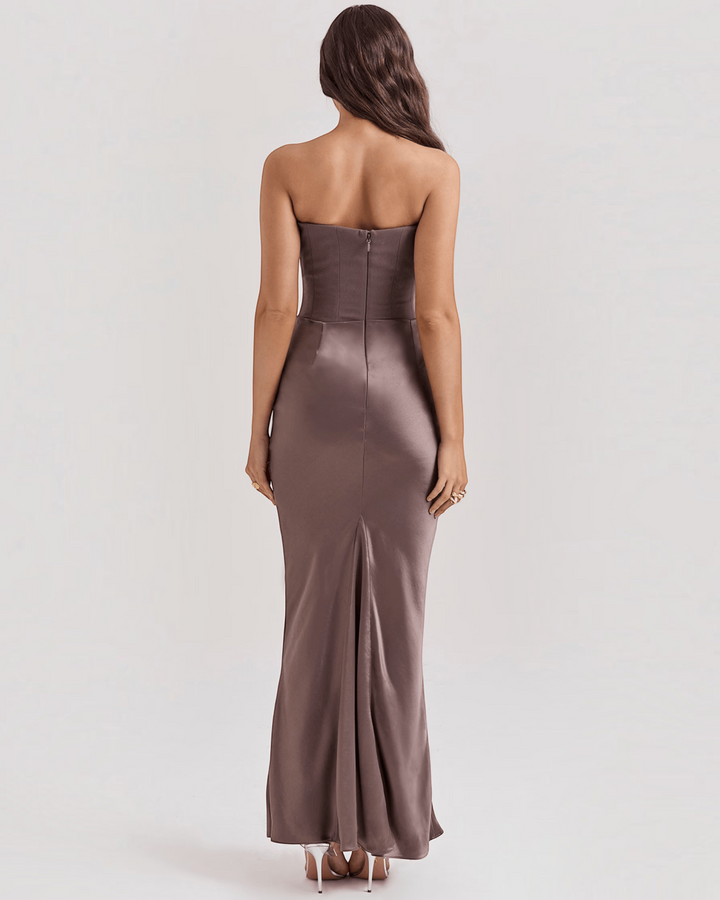 Luna Moda Serene strapless satin evening gown in a muted taupe shade, back view on a model with long wavy hair.