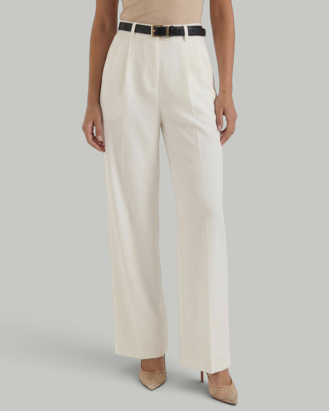 Luna Moda white high-waisted wide-leg trousers with front pleats and a black belt, worn with a beige top.