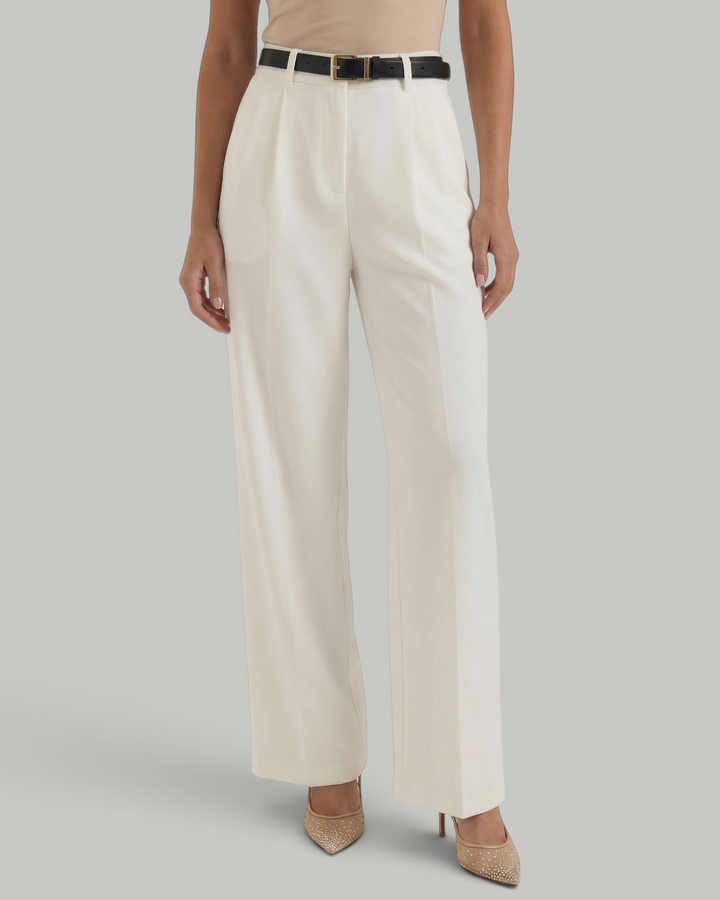 Luna Moda white high-waisted wide-leg trousers with front pleats and a black belt, worn with a beige top.
