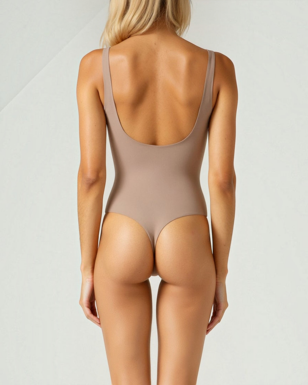 Luna Moda chocolate brown thong bodysuit with high-cut leg and square neckline, back view on a blonde model.