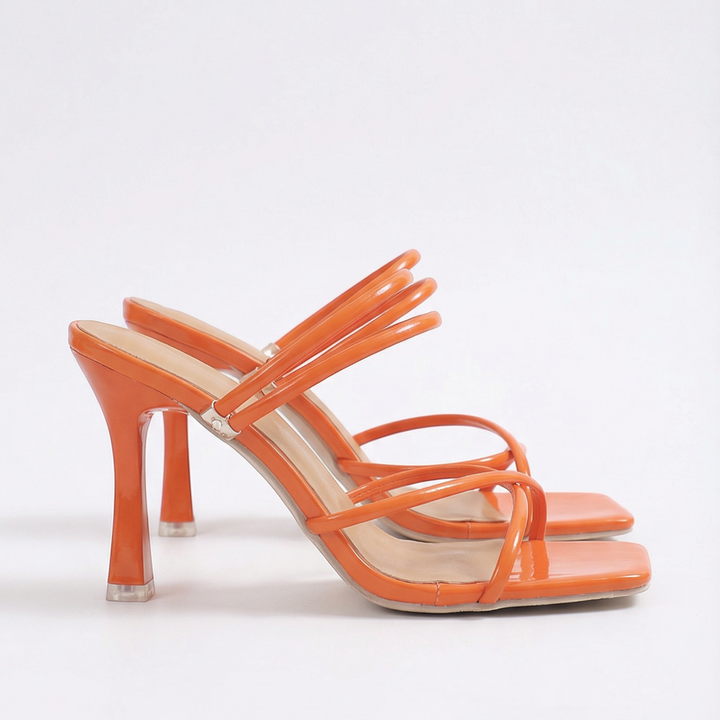 Luna Moda orange high-heeled sandals with thin crisscross straps and a modern square toe design.