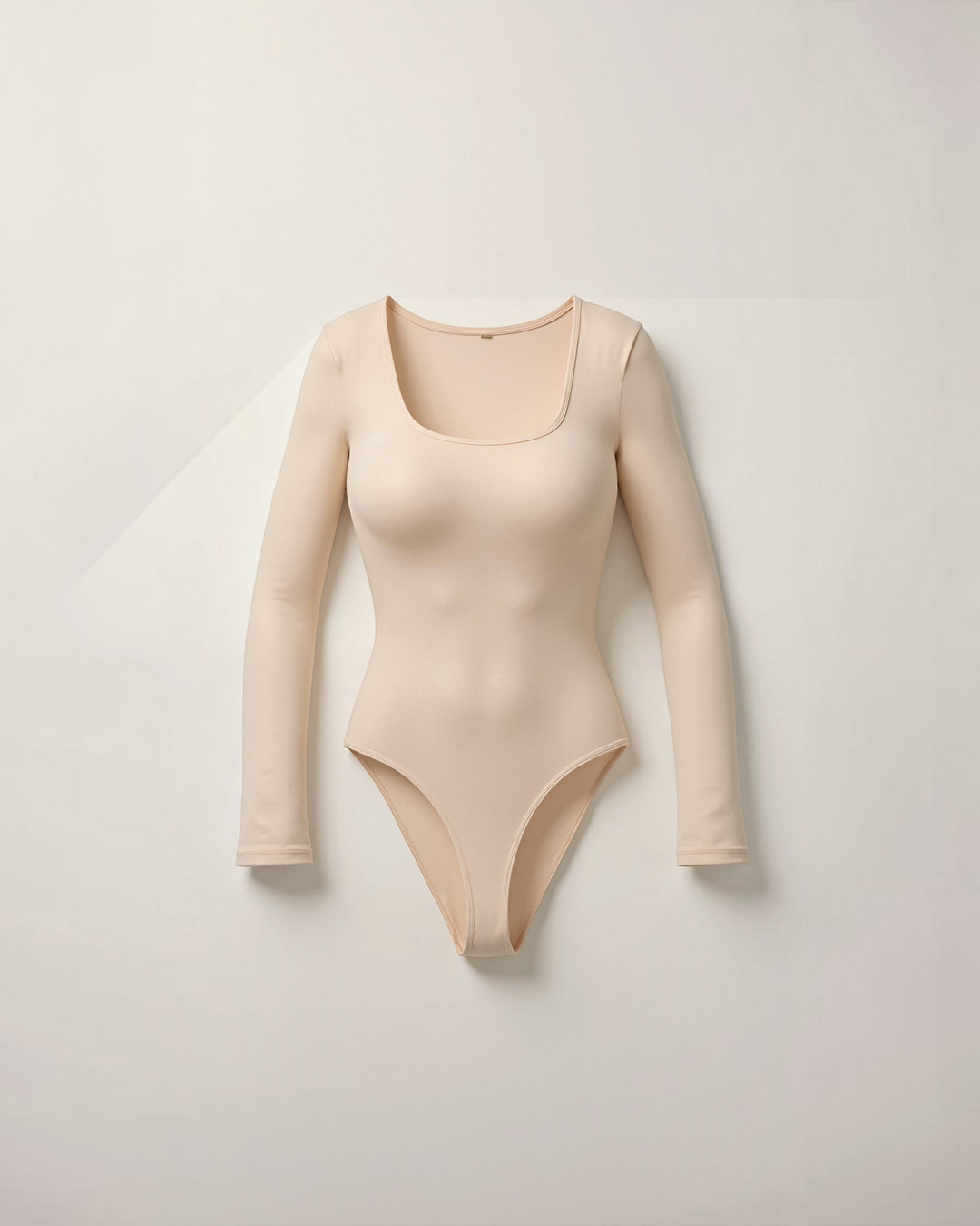 Luna Moda beige long sleeve thong bodysuit with a square neckline made from ultra-soft seamless stretch fabric.