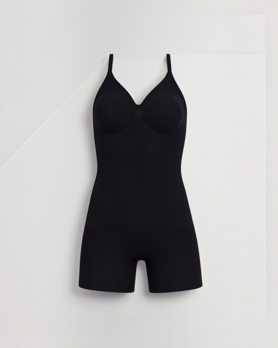 Luna Moda black seamless mid-thigh shaping bodysuit with integrated cups and adjustable straps for a smooth silhouette.