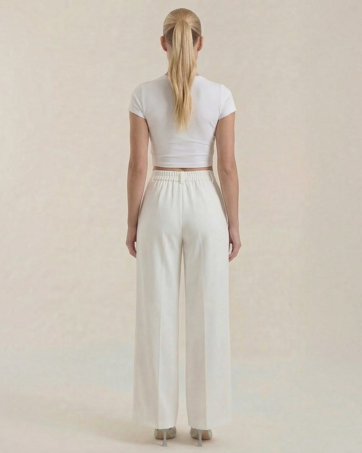 Luna Moda high-waisted white palazzo trousers with a fluid wide-leg fit, worn by a woman from the back view.