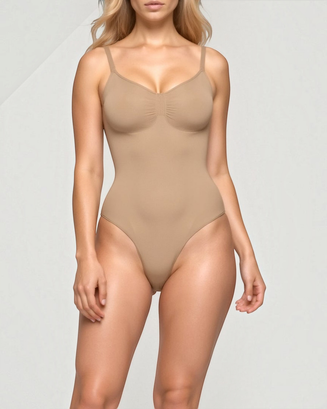 Luna Moda seamless beige shaping bodysuit with a V-neckline and thin spaghetti straps on a model