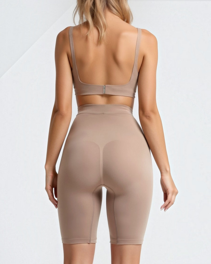 Luna Moda high-waisted seamless knee-length beige shaping shorts worn by a woman, back view.