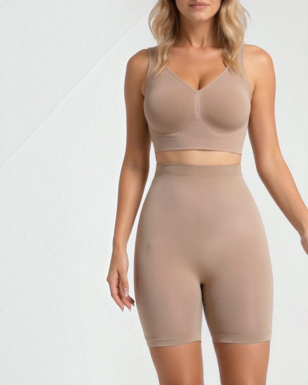 Luna Moda high-waisted seamless beige shaping shorts reaching the knee, worn by a woman for a smooth silhouette.