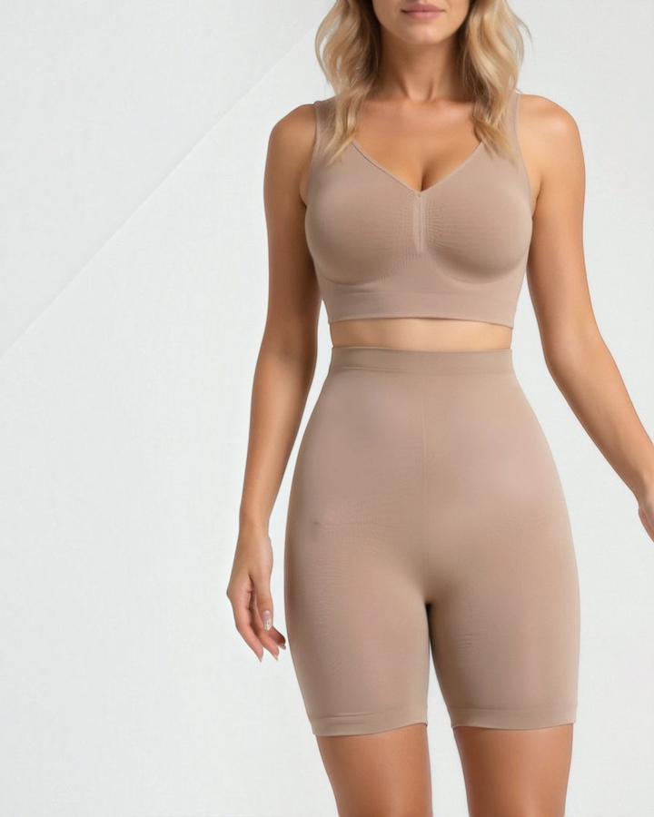 Luna Moda high-waisted seamless beige shaping shorts reaching the knee, worn by a woman for a smooth silhouette.