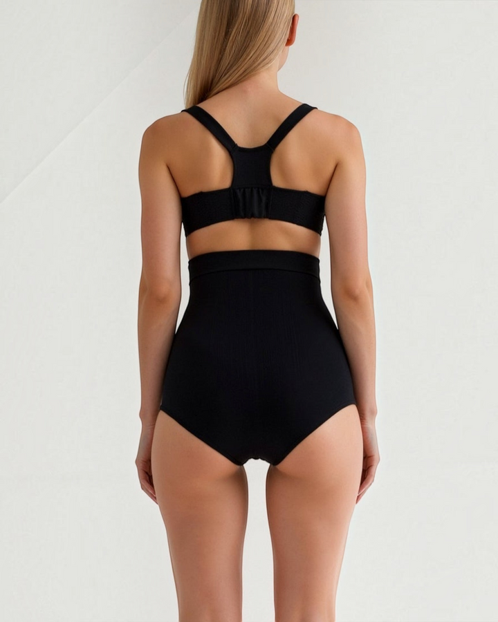 Luna Moda high-waisted black seamless shaping briefs worn by a woman, back view showing smooth silhouette.