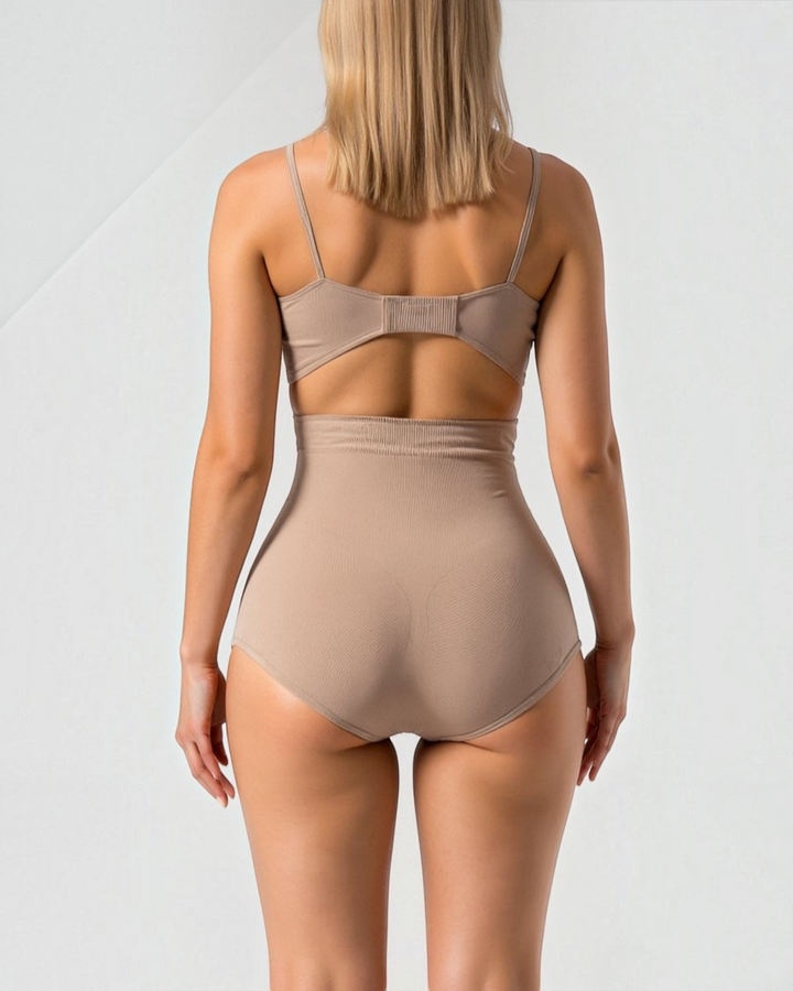 Luna Moda high-waisted beige shaping briefs with seamless edges worn by a model, back view.
