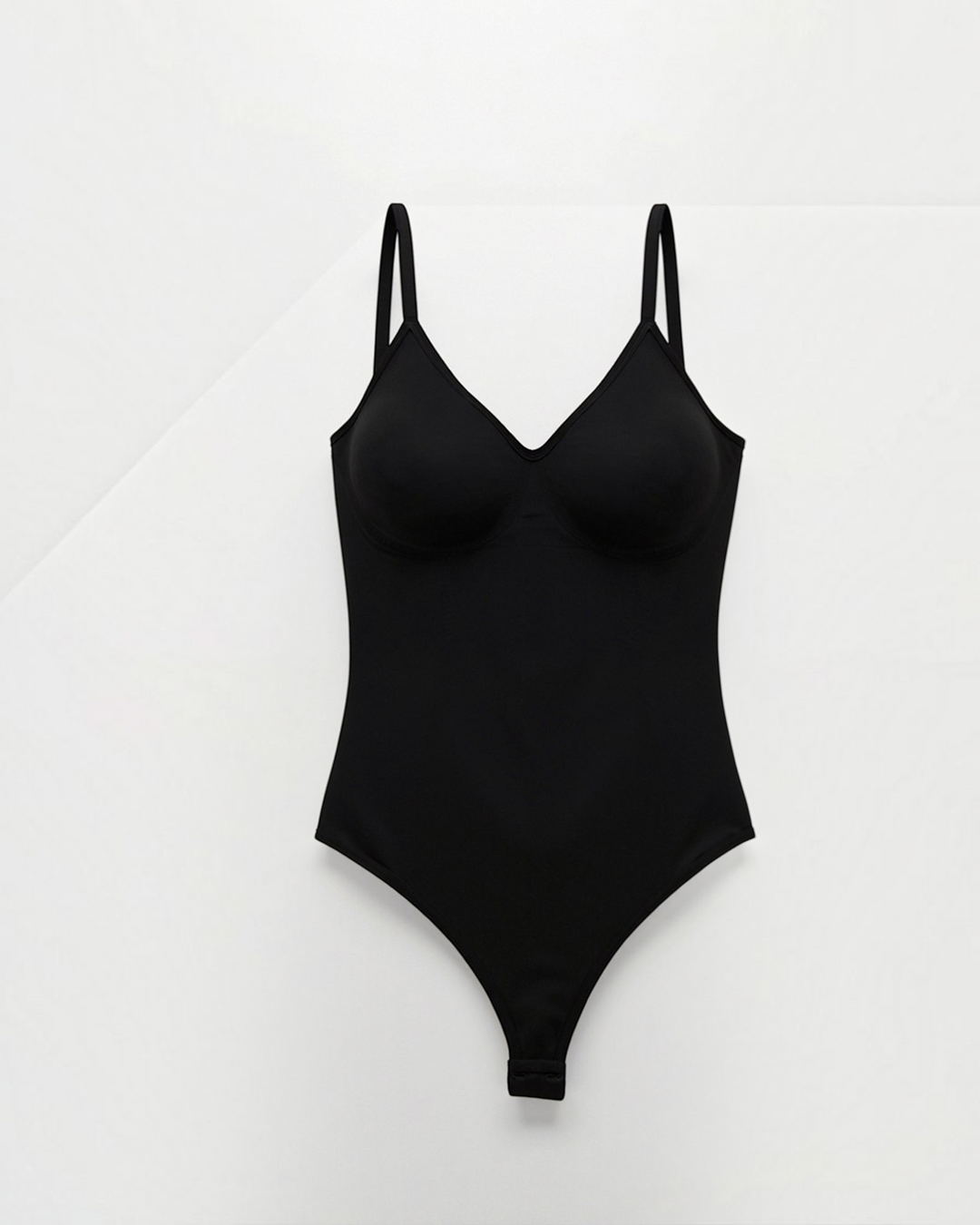 Luna Moda black seamless shaping bodysuit with a V-neck, thin straps, and a low back design for a smooth silhouette.