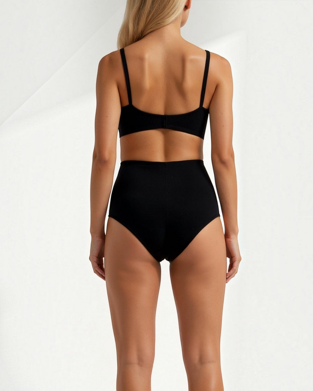 Luna Moda black seamless mid-waist shaping briefs with ribbed texture worn by a blonde model from the back view.