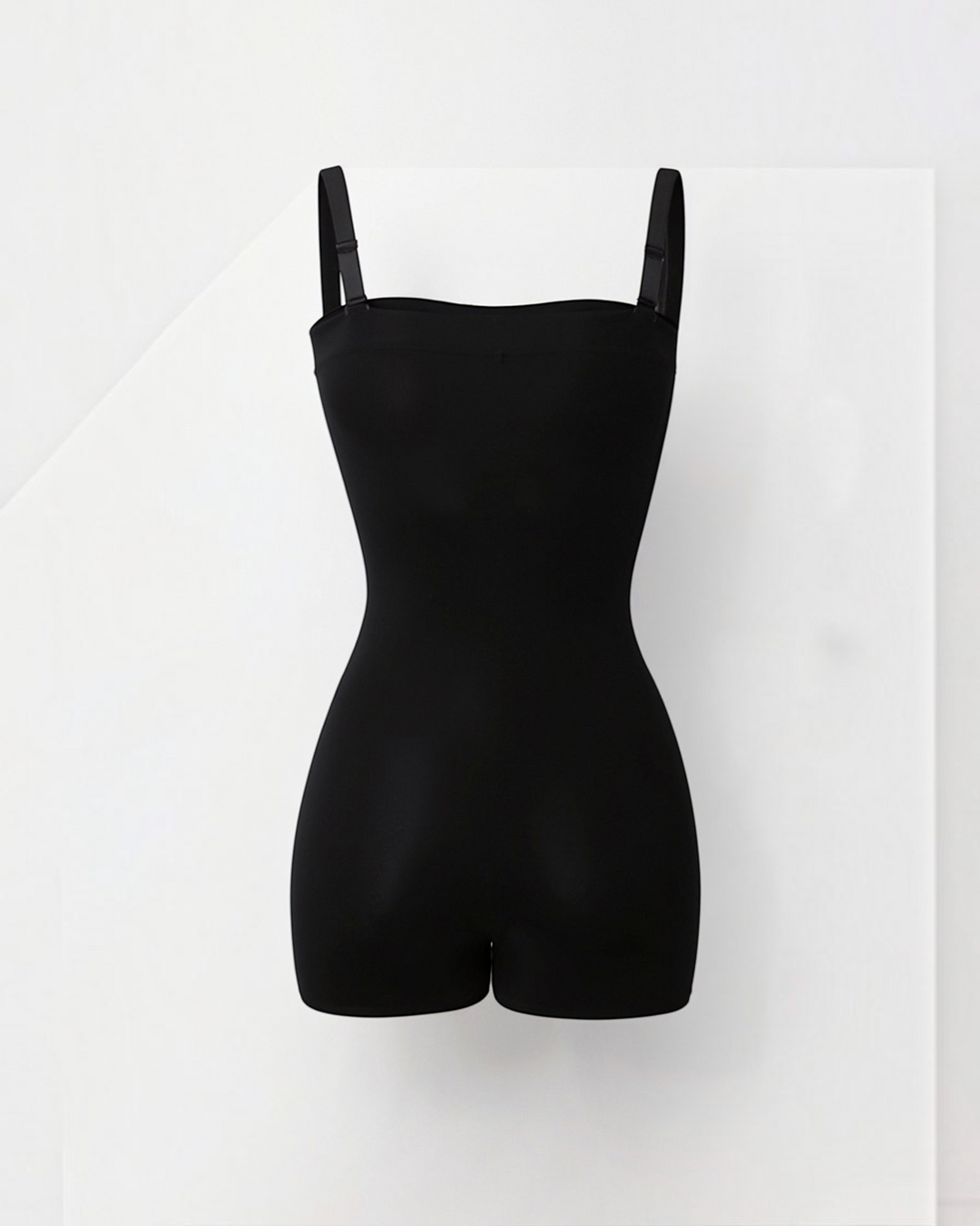 Luna Moda black seamless shaping bodysuit with shorts and adjustable straps for a smooth silhouette.