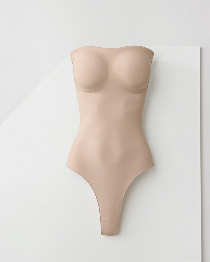Luna Moda nude seamless bandeau thong bodysuit with high-cut leg for a smooth, sculpting silhouette.