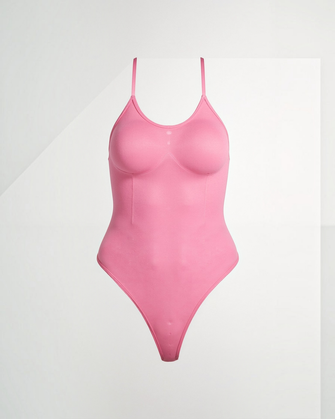 Luna Moda pink snatched thong bodysuit with boat neckline, adjustable straps, and smoothing compression fabric.