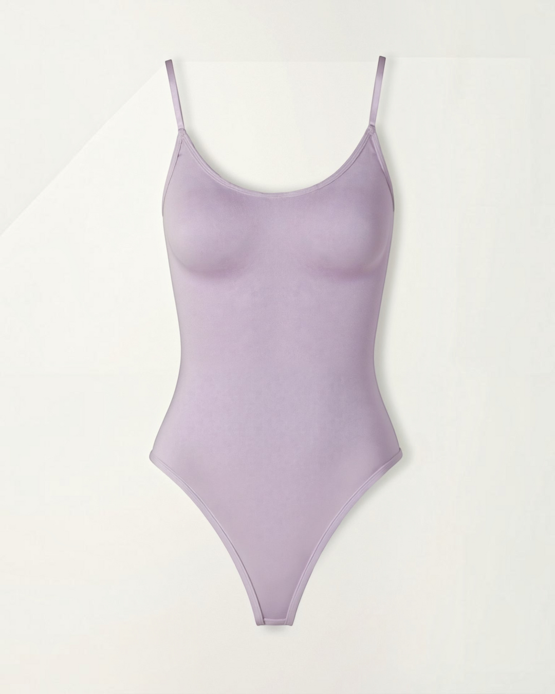 Luna Moda Snatched lavender thong bodysuit with a scoop neckline, adjustable straps, and seamless compression fabric.