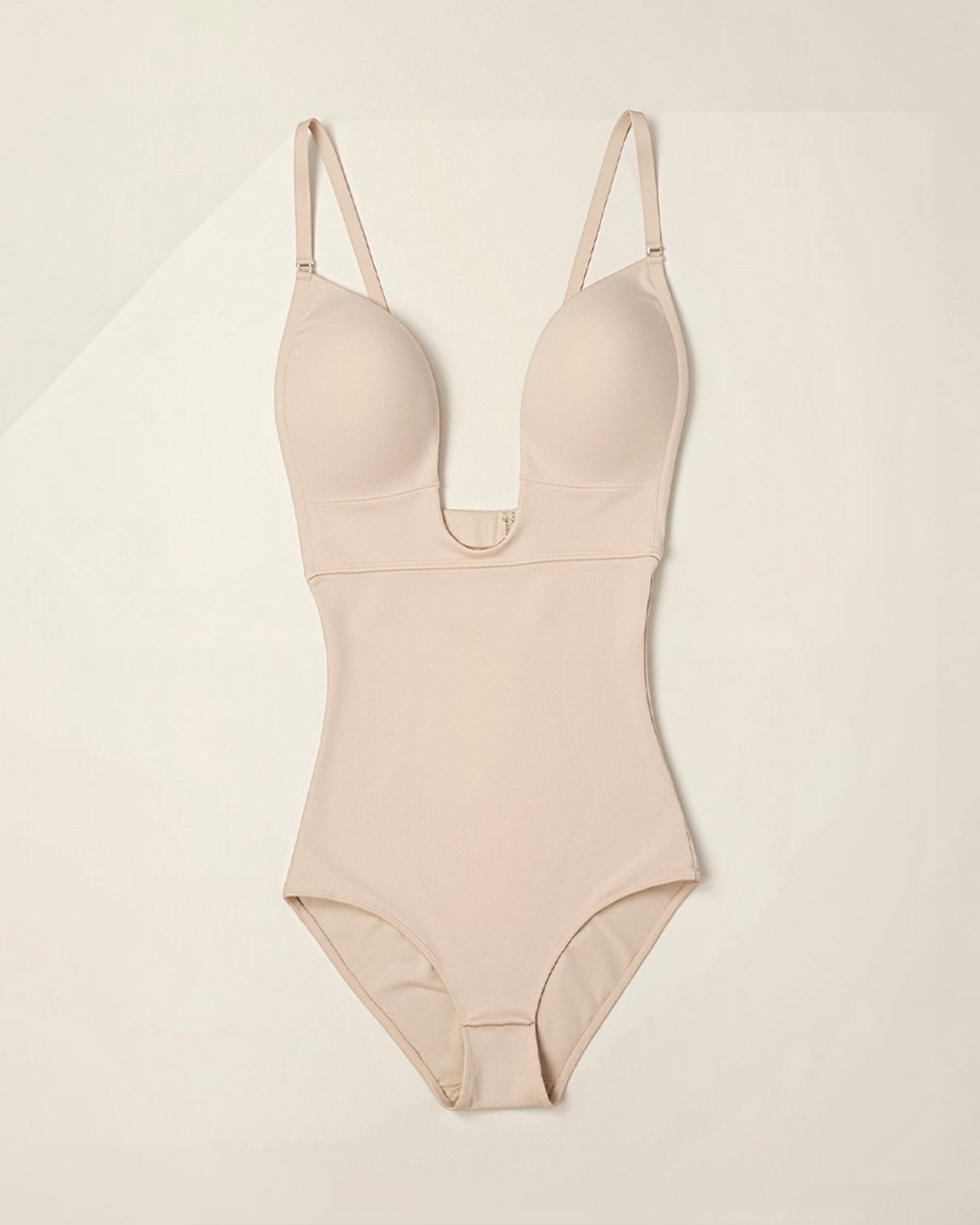 Luna Moda beige seamless thong bodysuit with underwire, deep neckline, and adjustable straps for a sculpted fit.