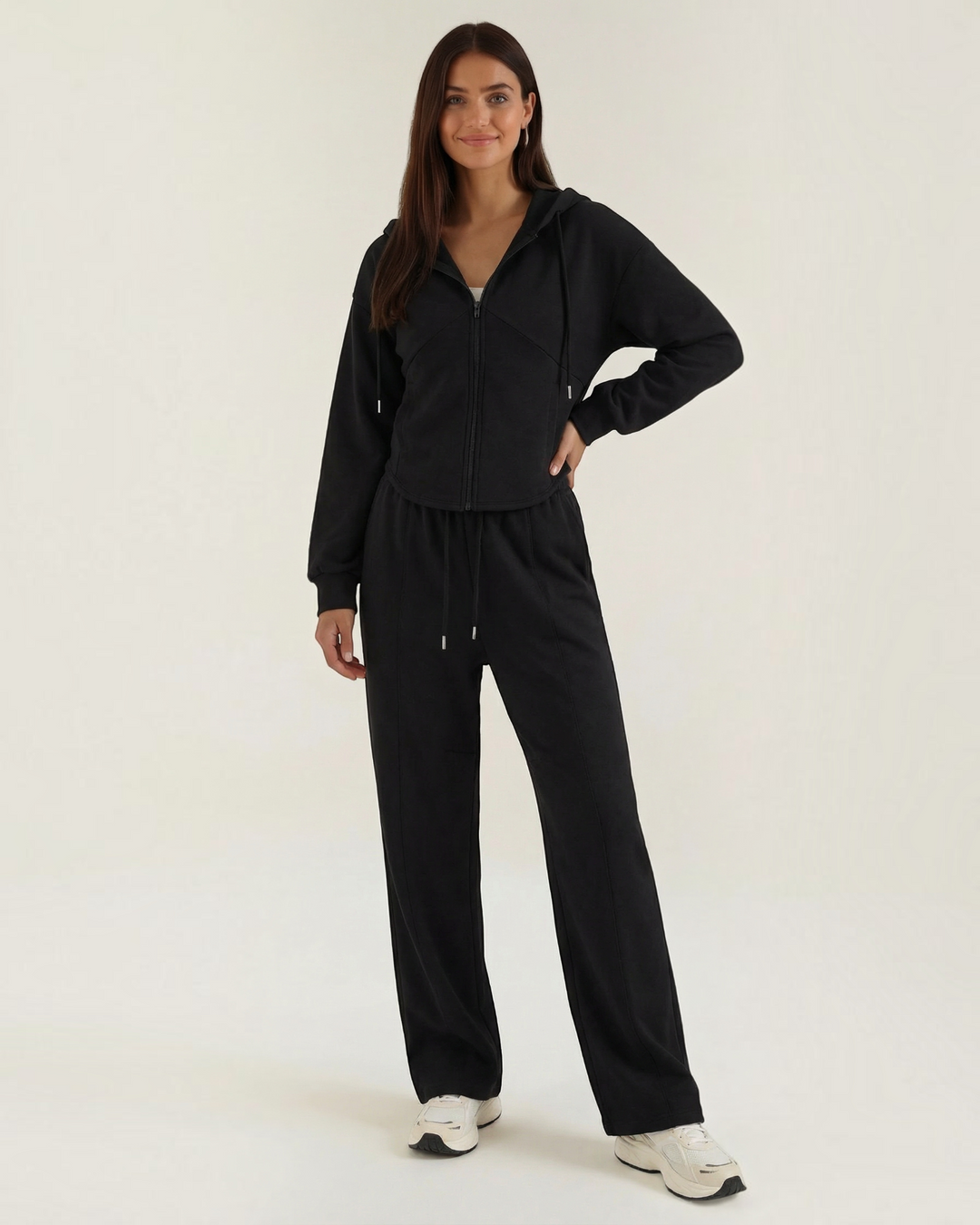 Luna Moda black two-piece lounge set featuring a zip-up hoodie and wide-leg trousers worn by a smiling model