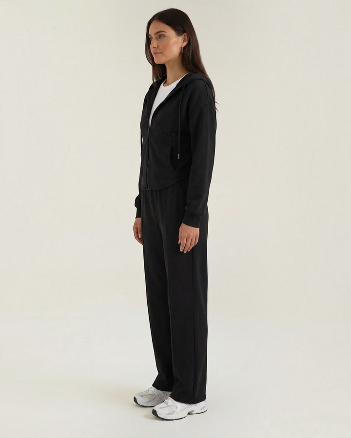 Luna Moda Yolanda black two-piece set with a zip-up hoodie and wide-leg trousers worn by a model in profile view.