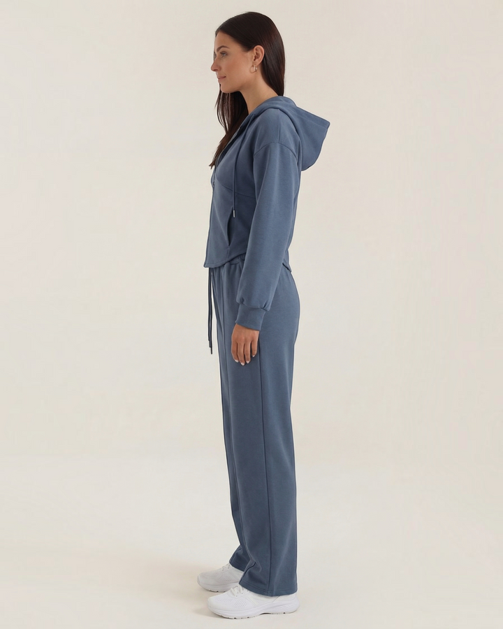 Luna Moda Yolanda blue two-piece lounge set with a hooded zip-up sweatshirt and wide-leg trousers, side view.