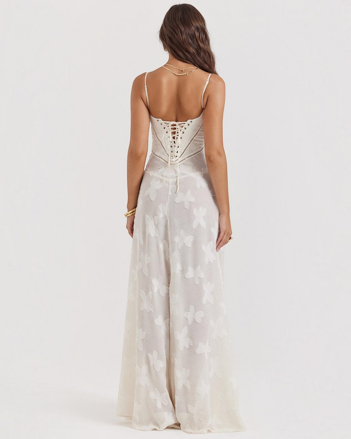 Luna Moda white maxi dress with butterfly embroidery, lace-up back detail, and spaghetti straps worn by a model.