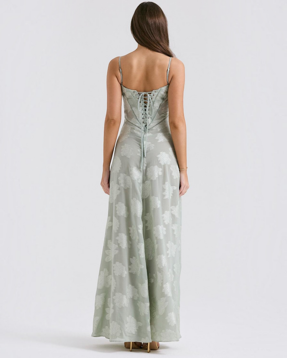 Luna Moda sage green floral maxi dress with a lace-up corset back and spaghetti straps, back view on a model.