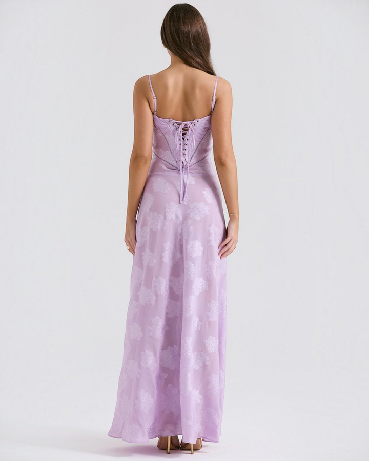 Luna Moda lilac maxi dress with floral pattern, spaghetti straps, and a lace-up corset back, worn by a model.