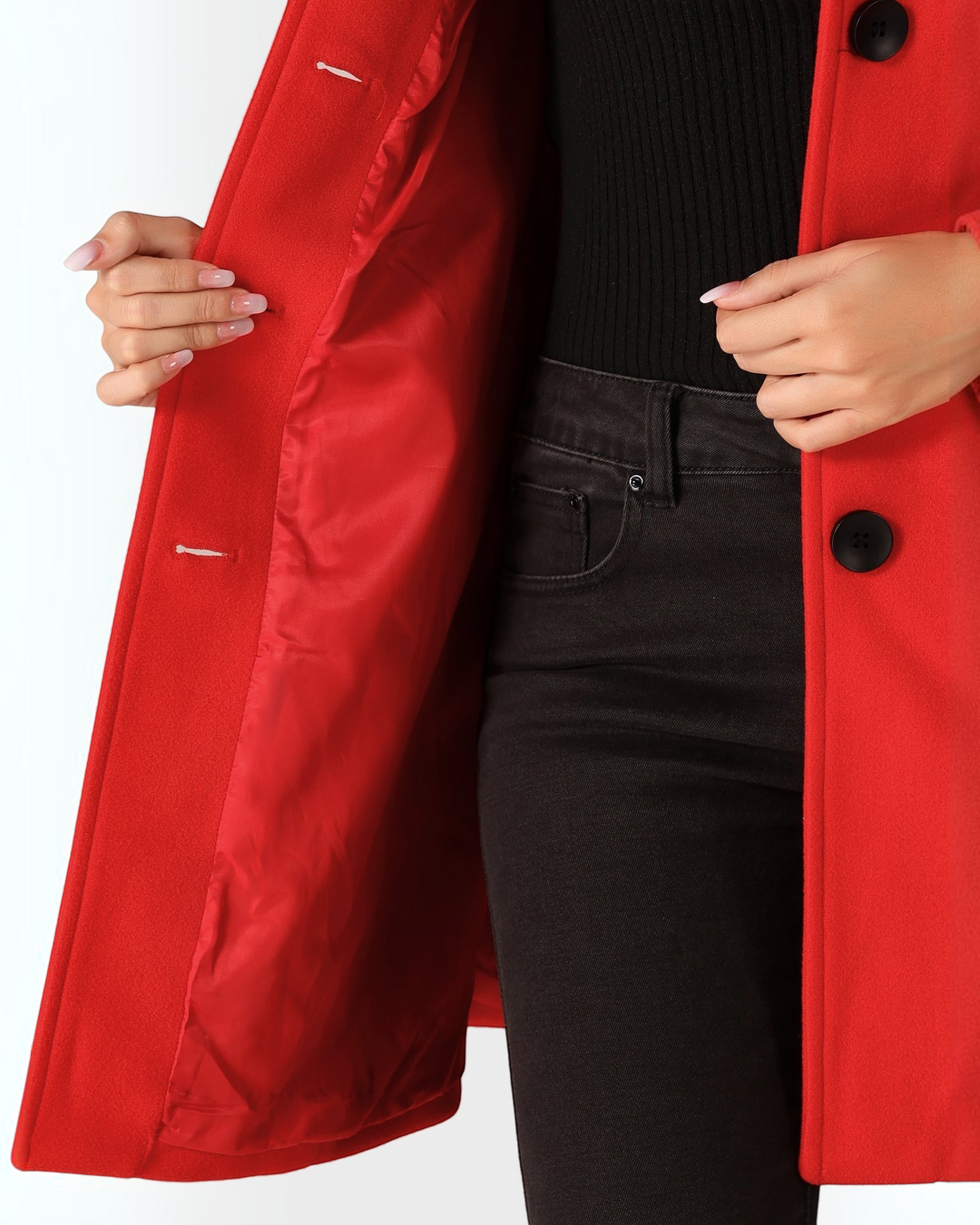 Luna Moda red fit and flare coat with black buttons and smooth inner lining worn over a black top and jeans